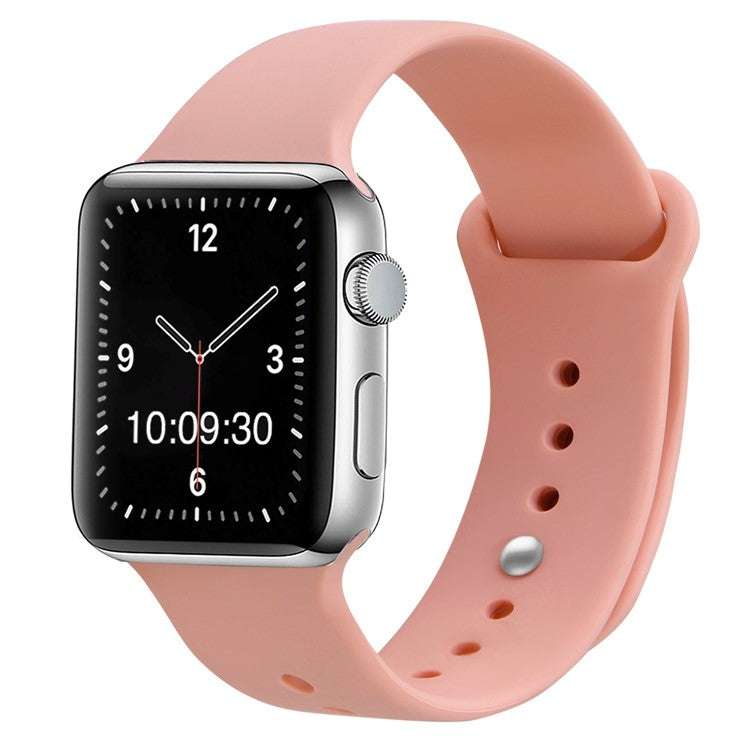 Silicone sport Apple Watch strap in pink, compatible with all sizes and generations, featuring pin and tuck closure for secure fit.